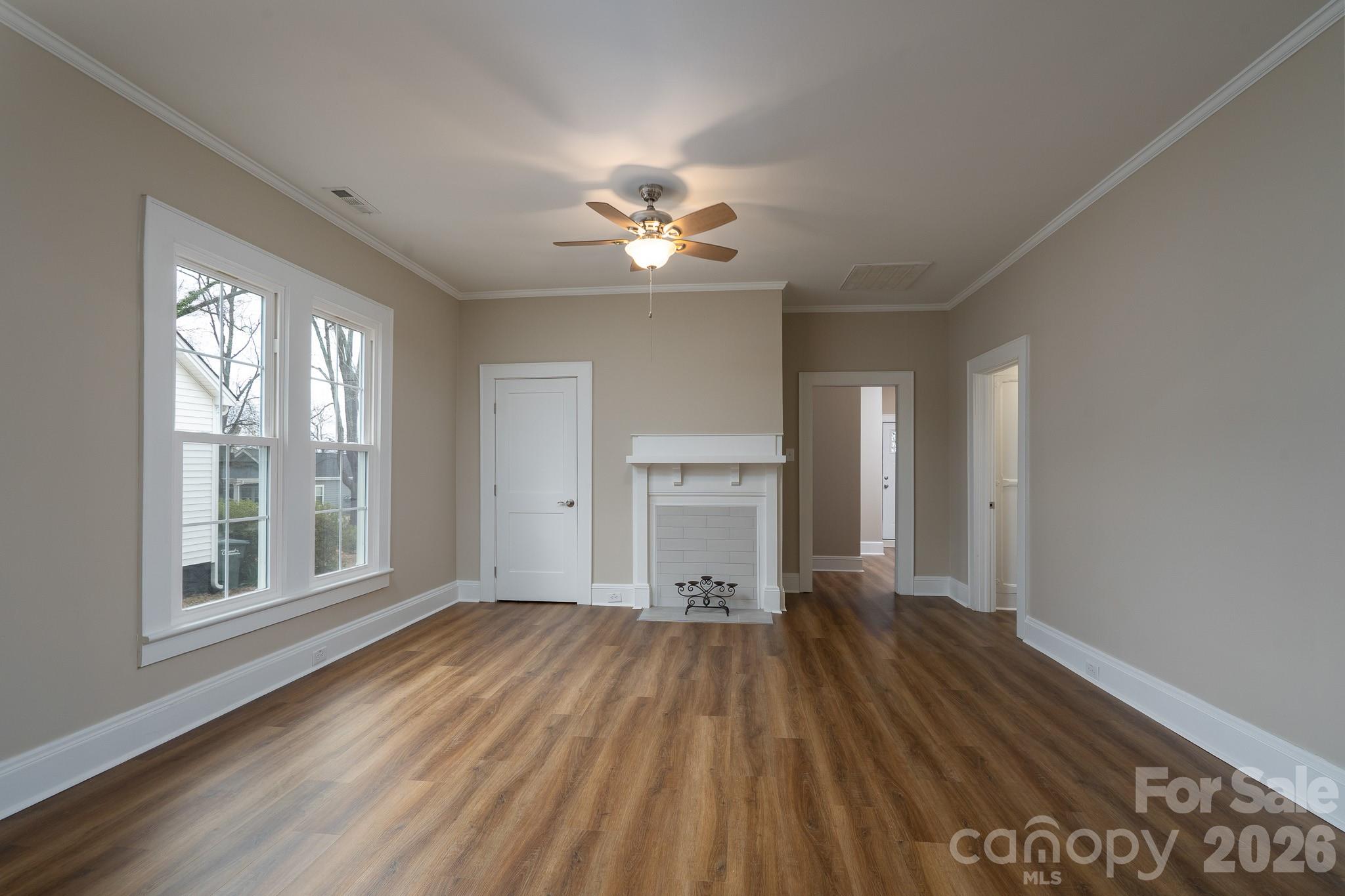 61 3rd Street Northwest Concord, NC 28027 - Photo 5 of 40 a view of empty room with wooden floor and fan
