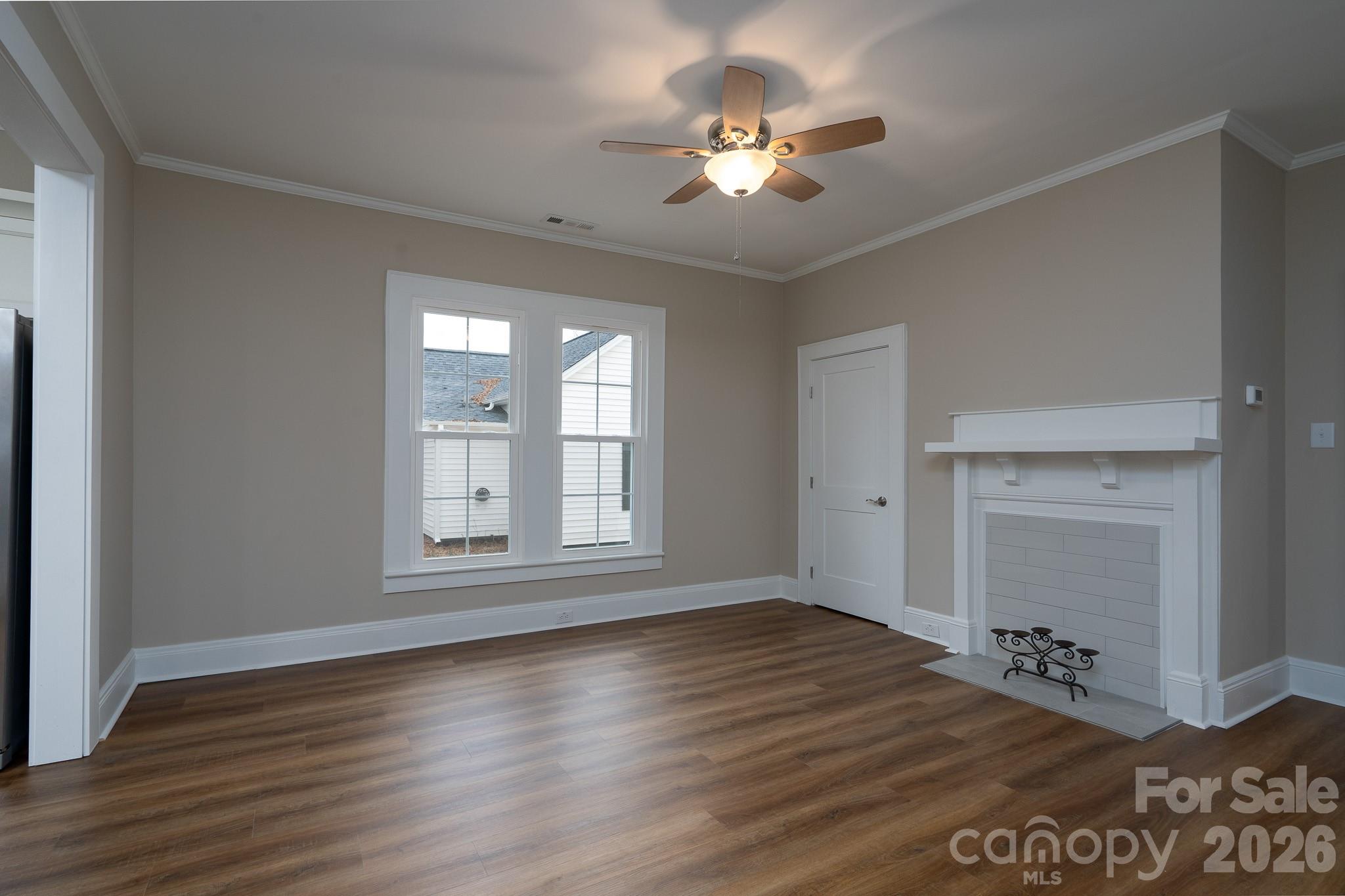 61 3rd Street Northwest Concord, NC 28027 - Photo 7 of 40 a view of an empty room with a window and wooden floor