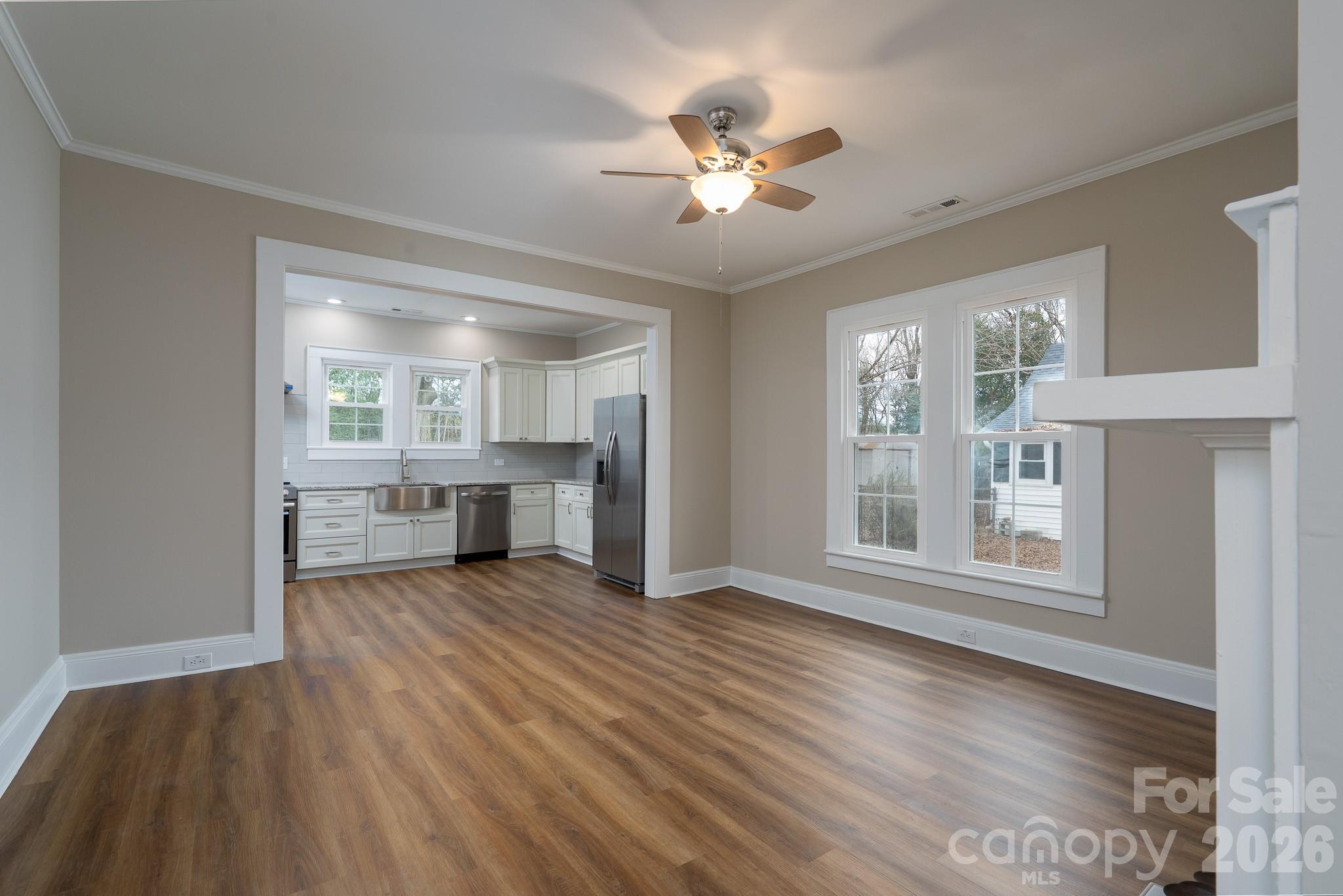 61 3rd Street Northwest Concord, NC 28027 - Photo 8 of 40 a view of a livingroom with furniture wooden floor and a kitchen