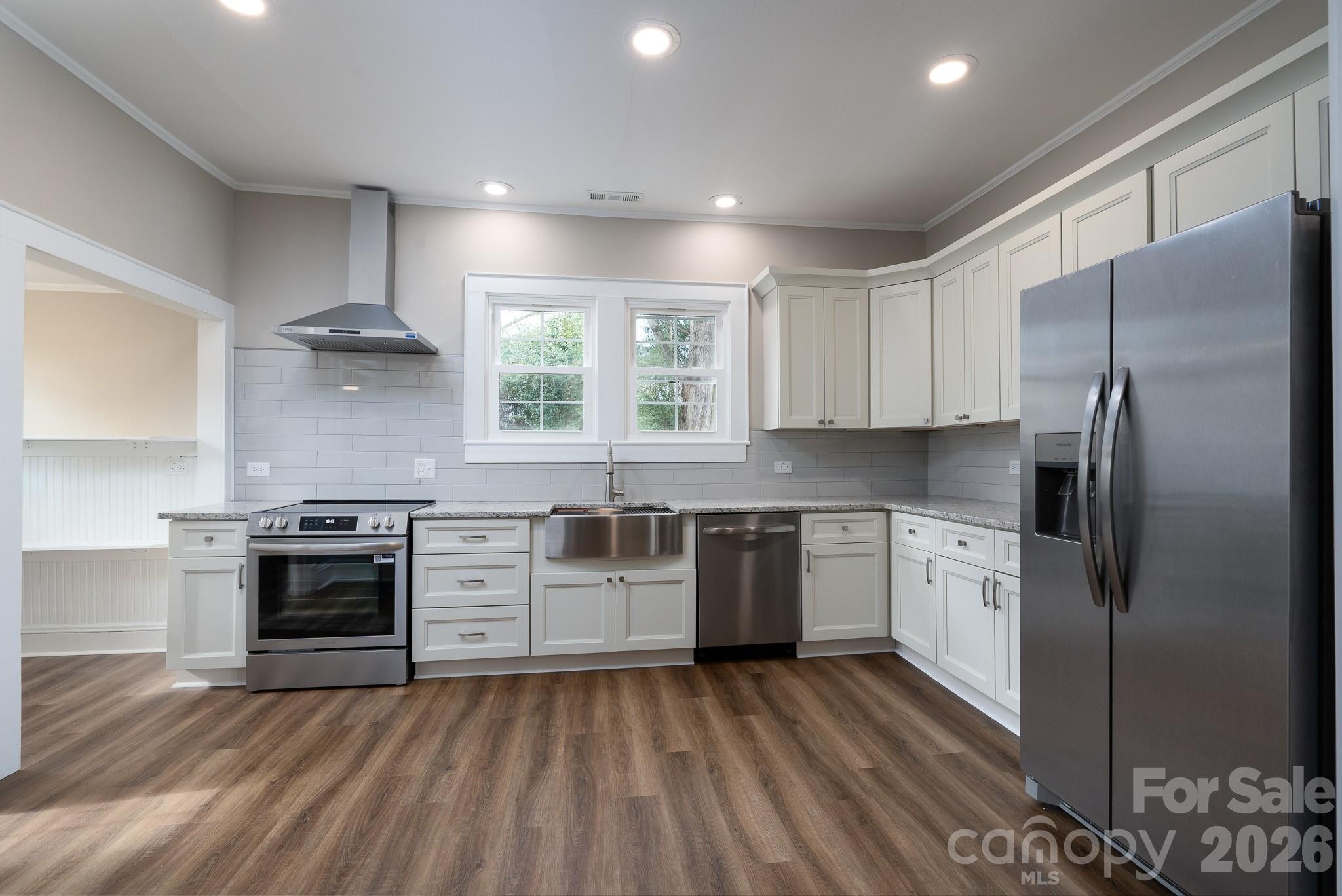 61 3rd Street Northwest Concord, NC 28027 - Photo 10 of 40 a kitchen with stainless steel appliances granite countertop a stove and a refrigerator
