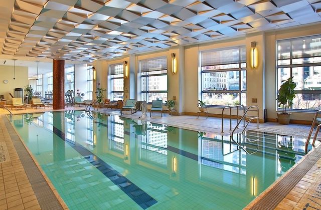 a living room with large windows and furniture