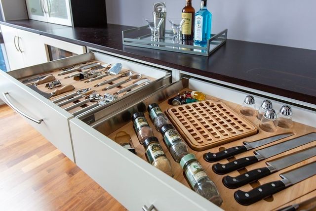 a kitchen with a stove a sink and cabinets