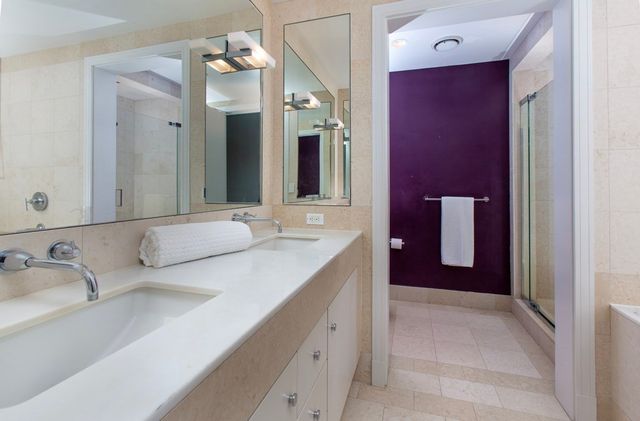 a bathroom with a double vanity sink and a mirror