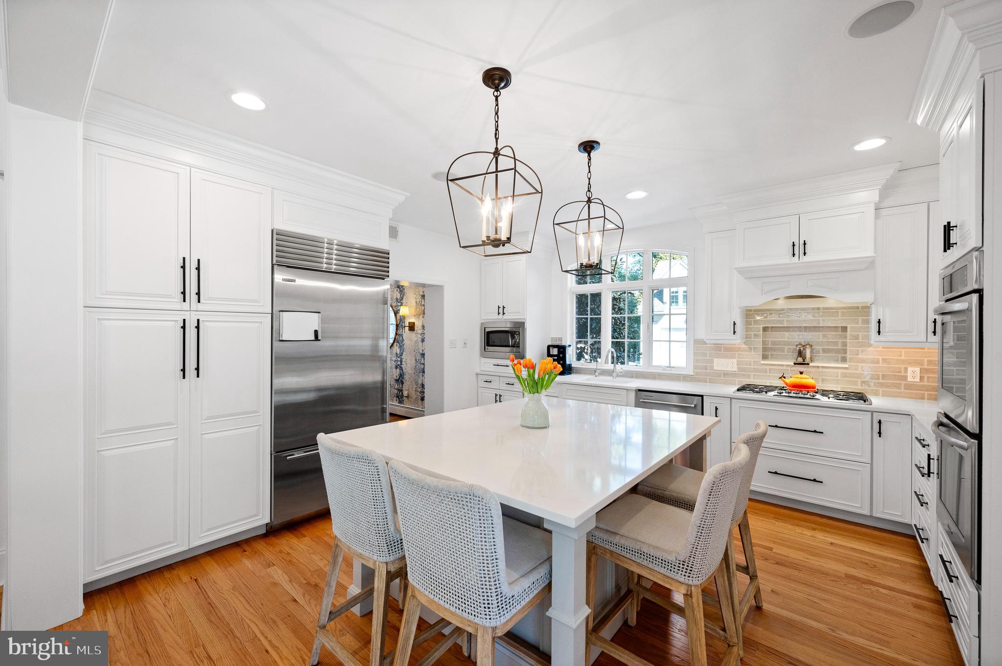 603 Foxfields Road Bryn Mawr, PA 19010 - Photo 15 of 51 a kitchen with stainless steel appliances a dining table chairs refrigerator and sink