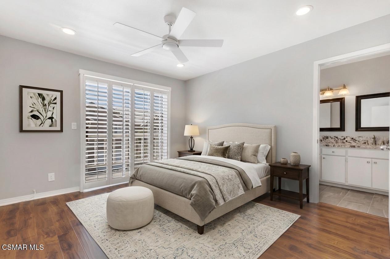 1980 Rory Lane, Unit 3 Simi Valley, CA 93063 - Photo 12 of 33 a bedroom with a large bed and a chandelier