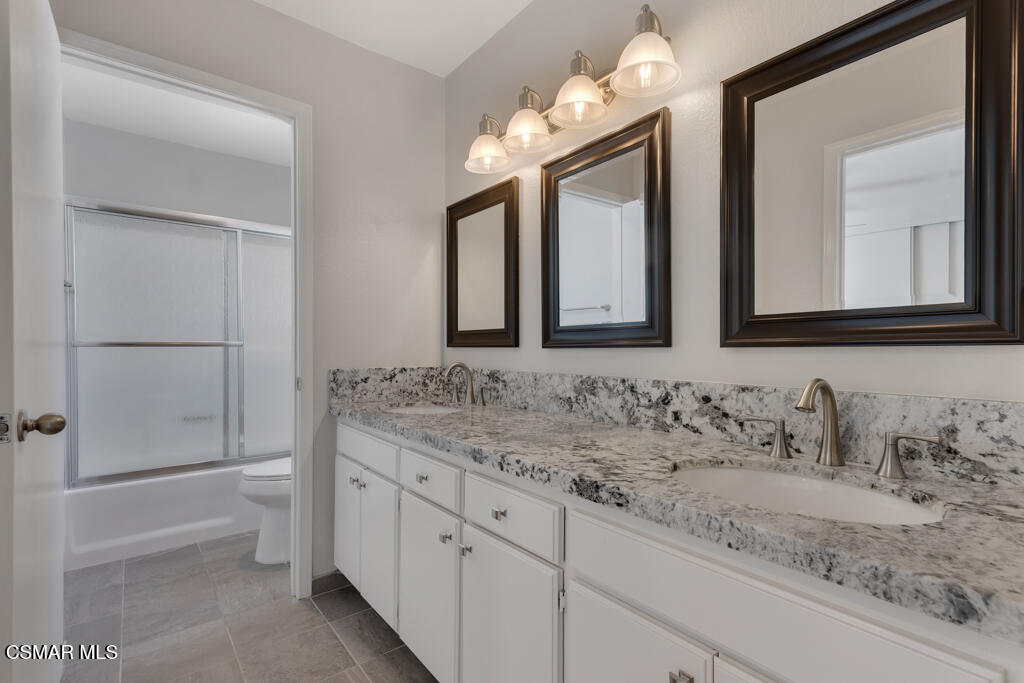 1980 Rory Lane, Unit 3 Simi Valley, CA 93063 - Photo 14 of 33 a bathroom with a double vanity sink and a mirror