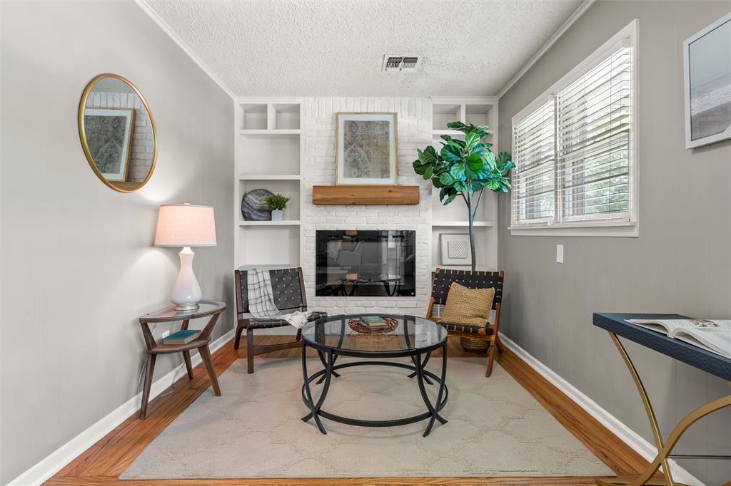 3924 North 30th Street Waco, TX 76708 - Photo 5 of 33 Clean cozy electric fireplace and cabinetry create a beautiful quiet place to sit, create an office, or enjoy as a dining area.