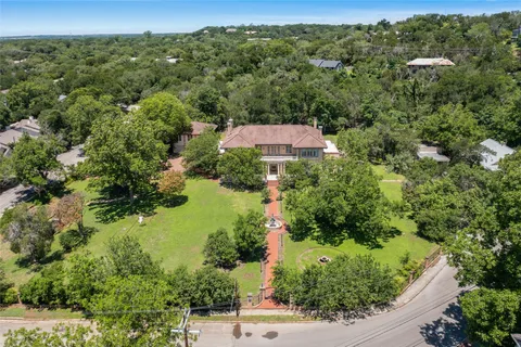 an aerial view of a house with a yard