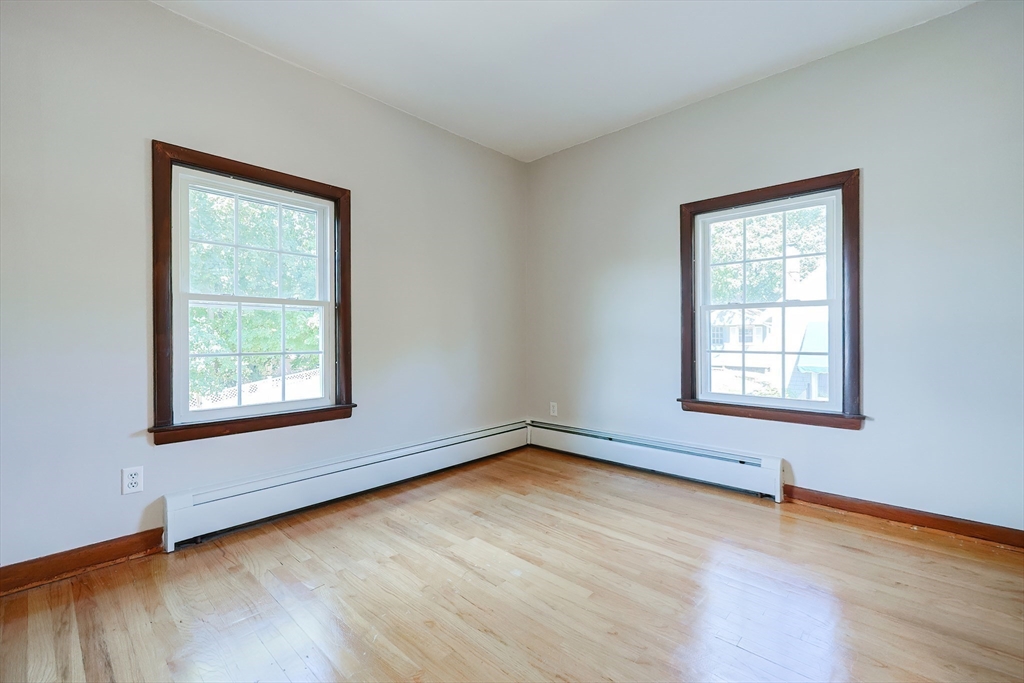 64 Smith Street North Attleboro, MA 02760 - Photo 14 of 42 a view of an empty room with wooden floor and a window