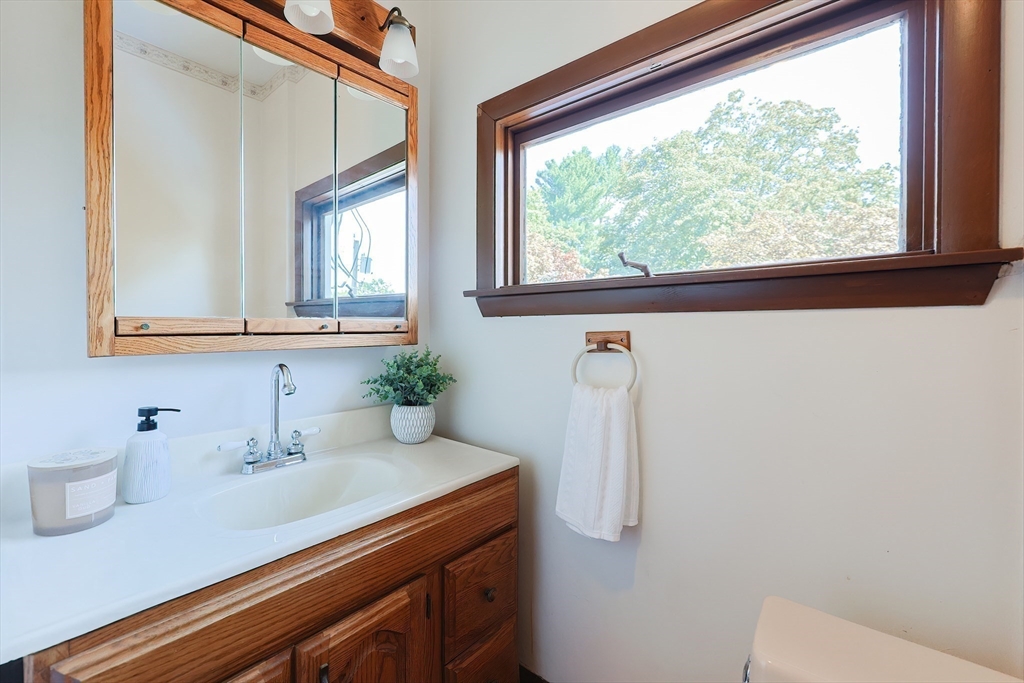 64 Smith Street North Attleboro, MA 02760 - Photo 16 of 42 a bathroom with a sink a mirror and a window