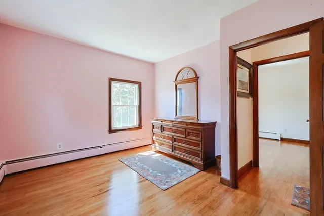 a view of room with window and wooden floor