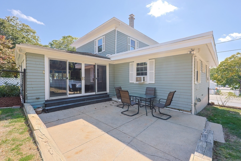 64 Smith Street North Attleboro, MA 02760 - Photo 25 of 42 a view of a patio with table and chairs with wooden fence
