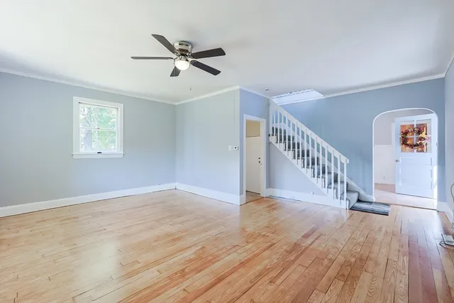 a view of a hallway with entryway wooden floor and windows