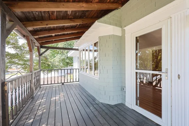 a view of outdoor space with wooden floor and windows