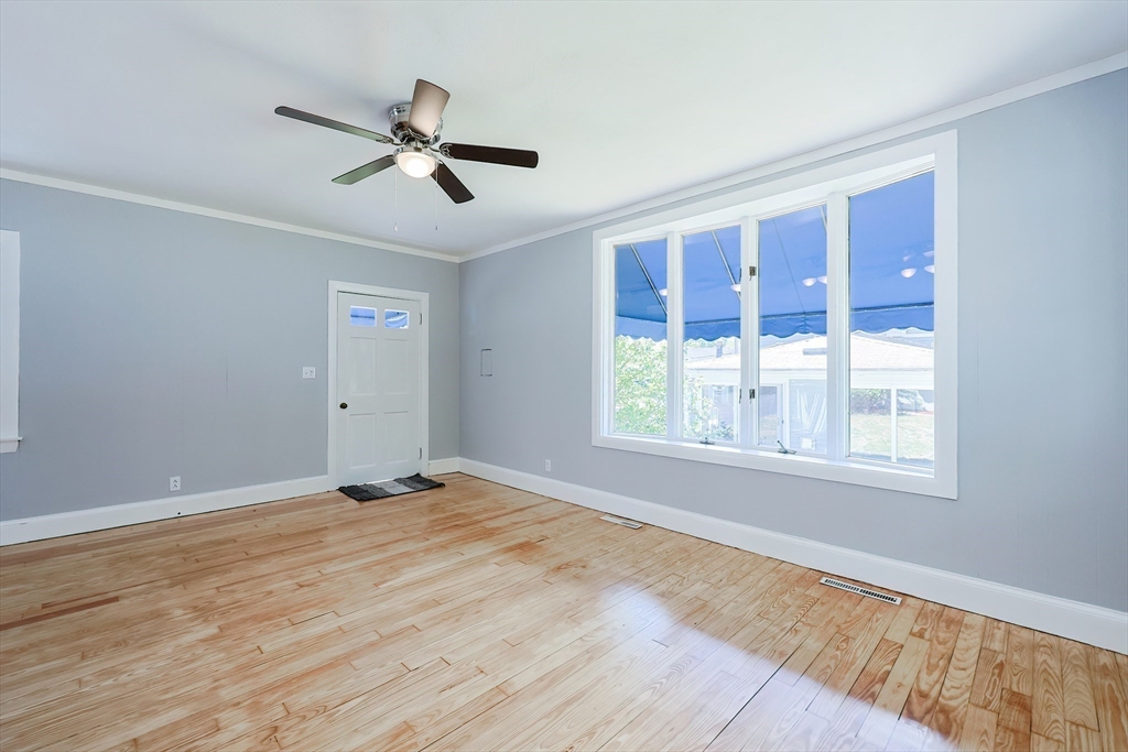 64 Smith Street North Attleboro, MA 02760 - Photo 31 of 42 a view of empty room with wooden floor and fan