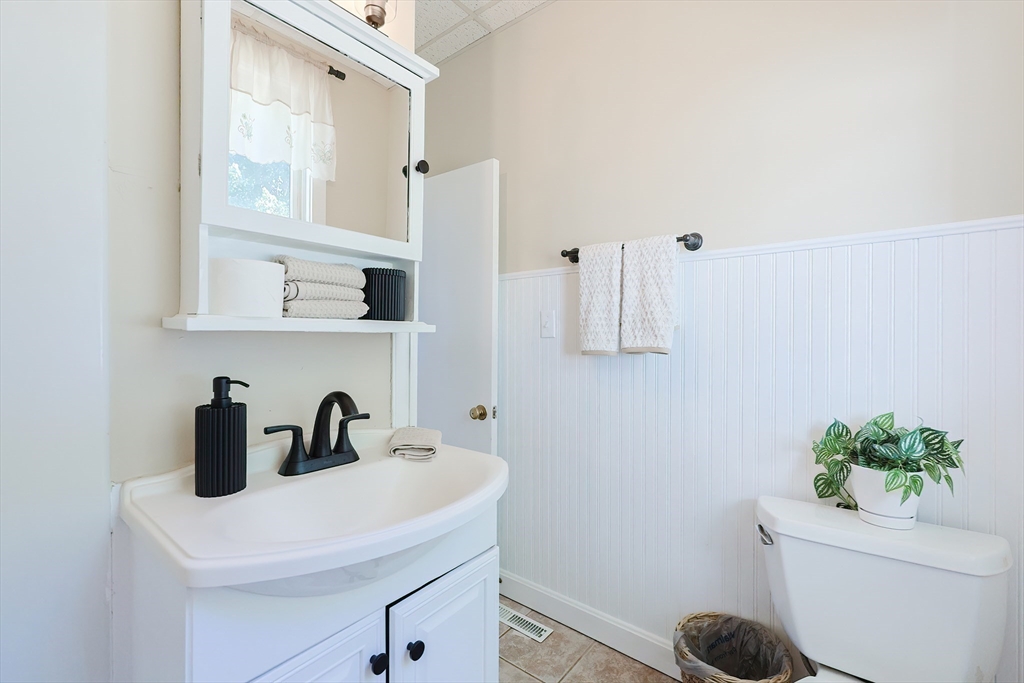64 Smith Street North Attleboro, MA 02760 - Photo 34 of 42 a bathroom with a sink a toilet and mirror