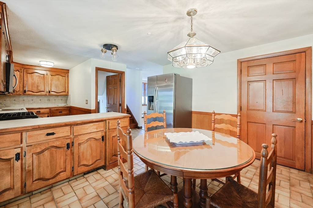 64 Smith Street North Attleboro, MA 02760 - Photo 8 of 42 a view of a dining room with furniture and a chandelier
