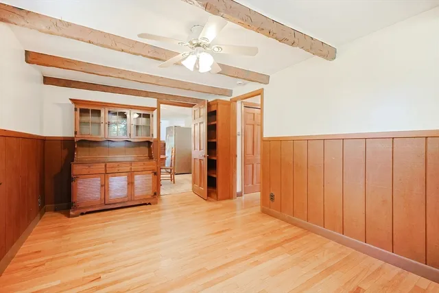 a view of a room with wooden floor and chandelier