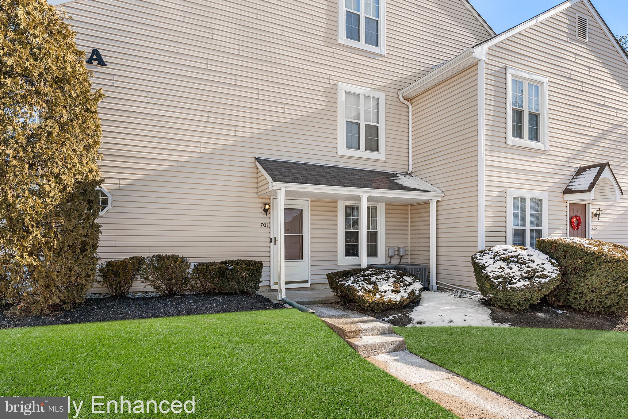 a front view of a house with a garden and plants