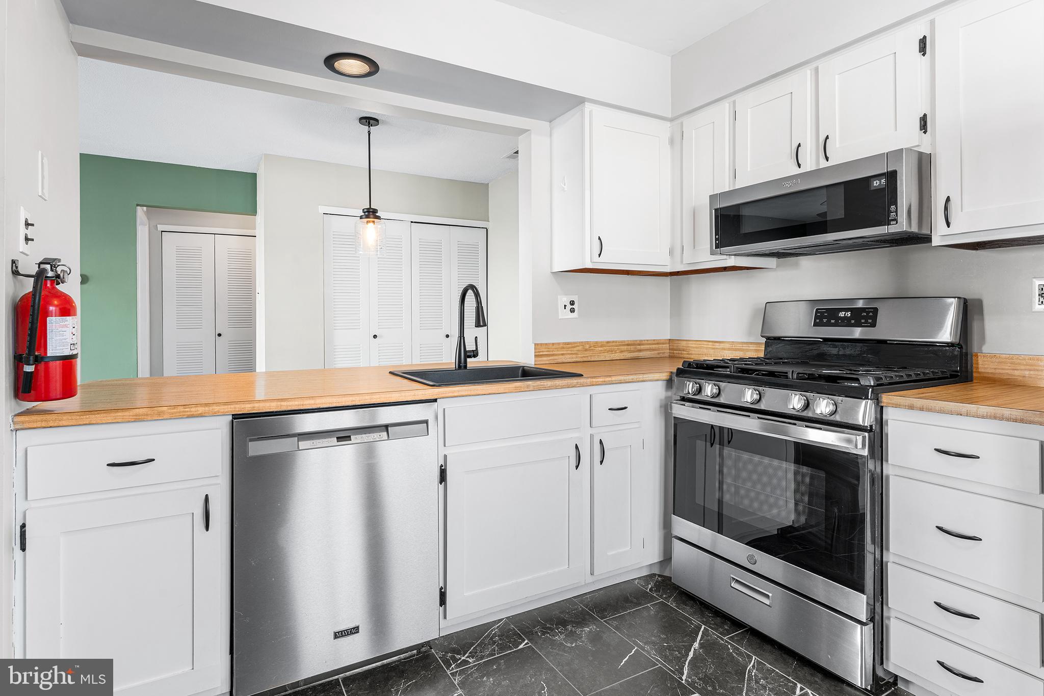 701 Sedgewick Court, Unit 701 Sewell, NJ 08080 - Photo 15 of 31 a kitchen with stainless steel appliances white cabinets and a stove a sink