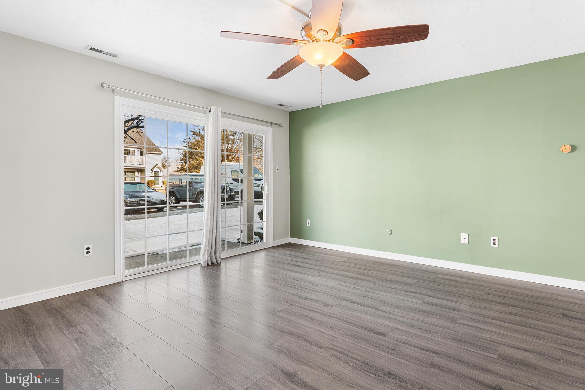 701 Sedgewick Court, Unit 701 Sewell, NJ 08080 - Photo 6 of 31 an empty room with wooden floor and windows