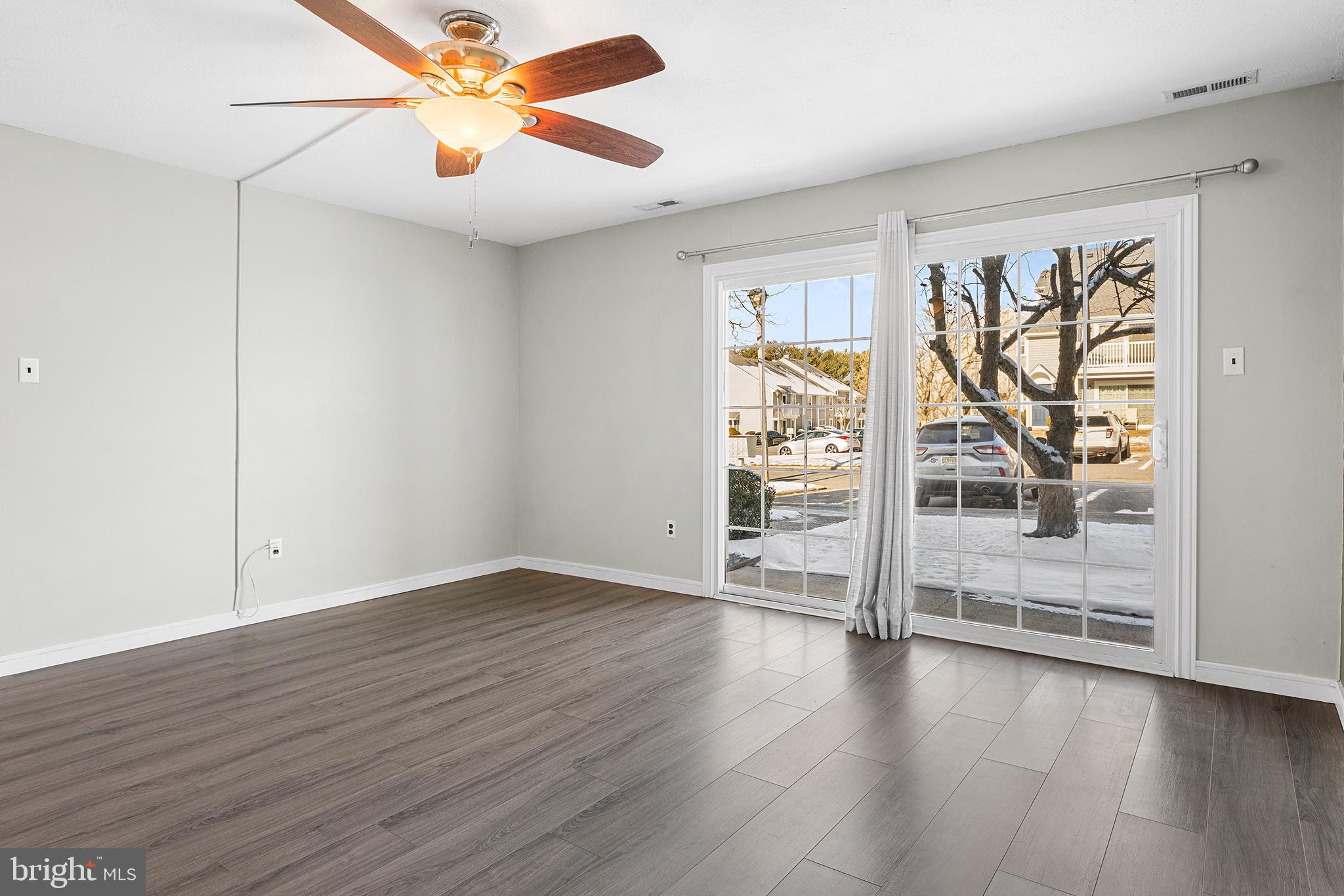 701 Sedgewick Court, Unit 701 Sewell, NJ 08080 - Photo 9 of 31 an empty room with wooden floor fan and windows