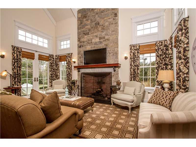 2 Bishops Gate Road Darien, CT 06820 - Photo 11 of 25 a living room with furniture a fireplace and a large window