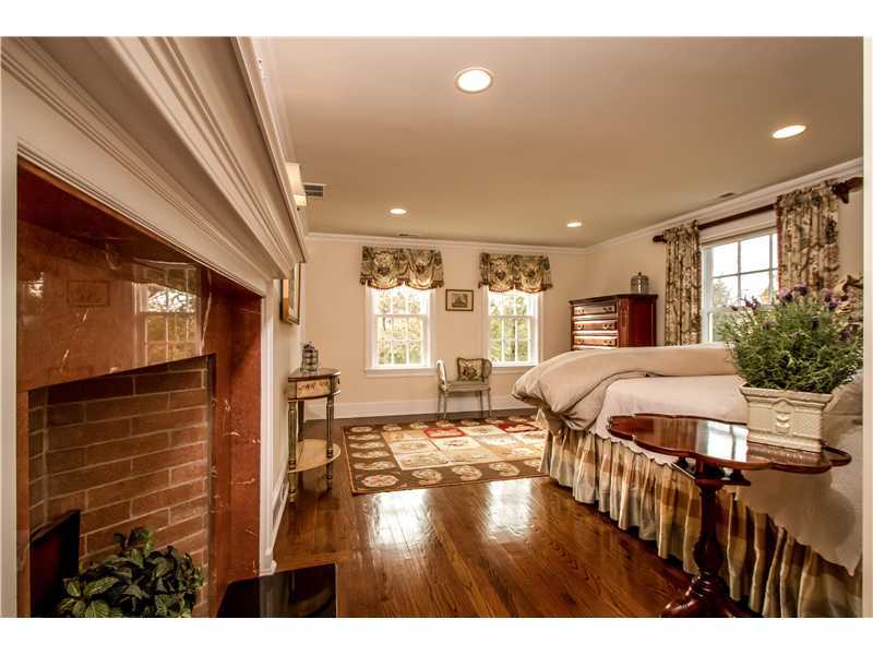 2 Bishops Gate Road Darien, CT 06820 - Photo 17 of 25 a bedroom with a bed and glass windows