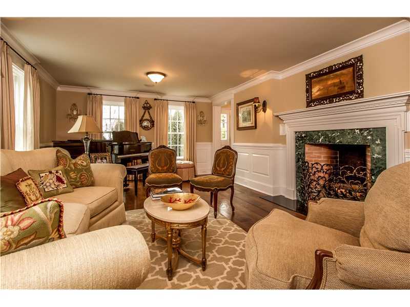 2 Bishops Gate Road Darien, CT 06820 - Photo 5 of 25 a living room with furniture a fireplace and a flat screen tv
