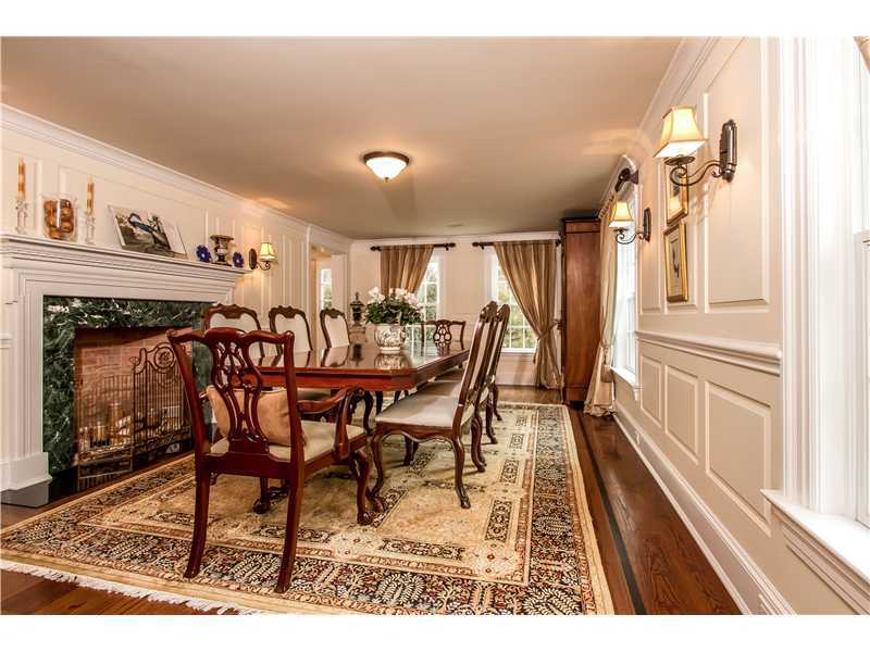 2 Bishops Gate Road Darien, CT 06820 - Photo 7 of 25 a view of a dining room with furniture and a fireplace