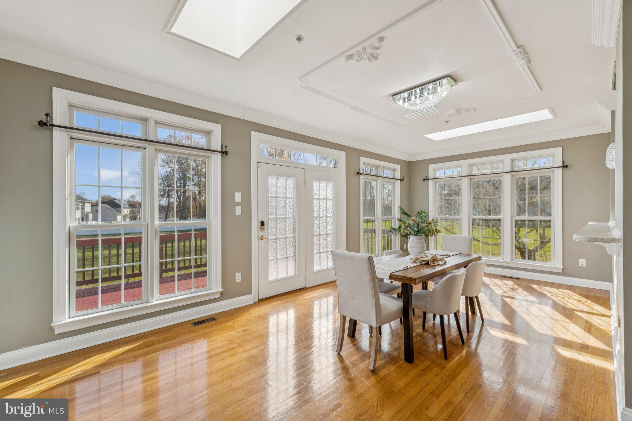 2205 Dhow Court Bowie, MD 20721 - Photo 11 of 40 a view of a dining room with furniture large windows and wooden floor