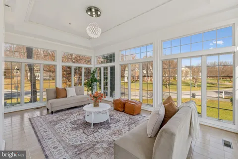 a living room with furniture and large windows
