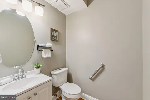 a white toilet sitting next to a bathroom sink