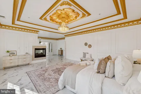 a bedroom with a bed and a fireplace