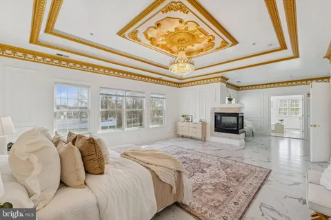 a spacious bedroom with a bed a couch and dresser