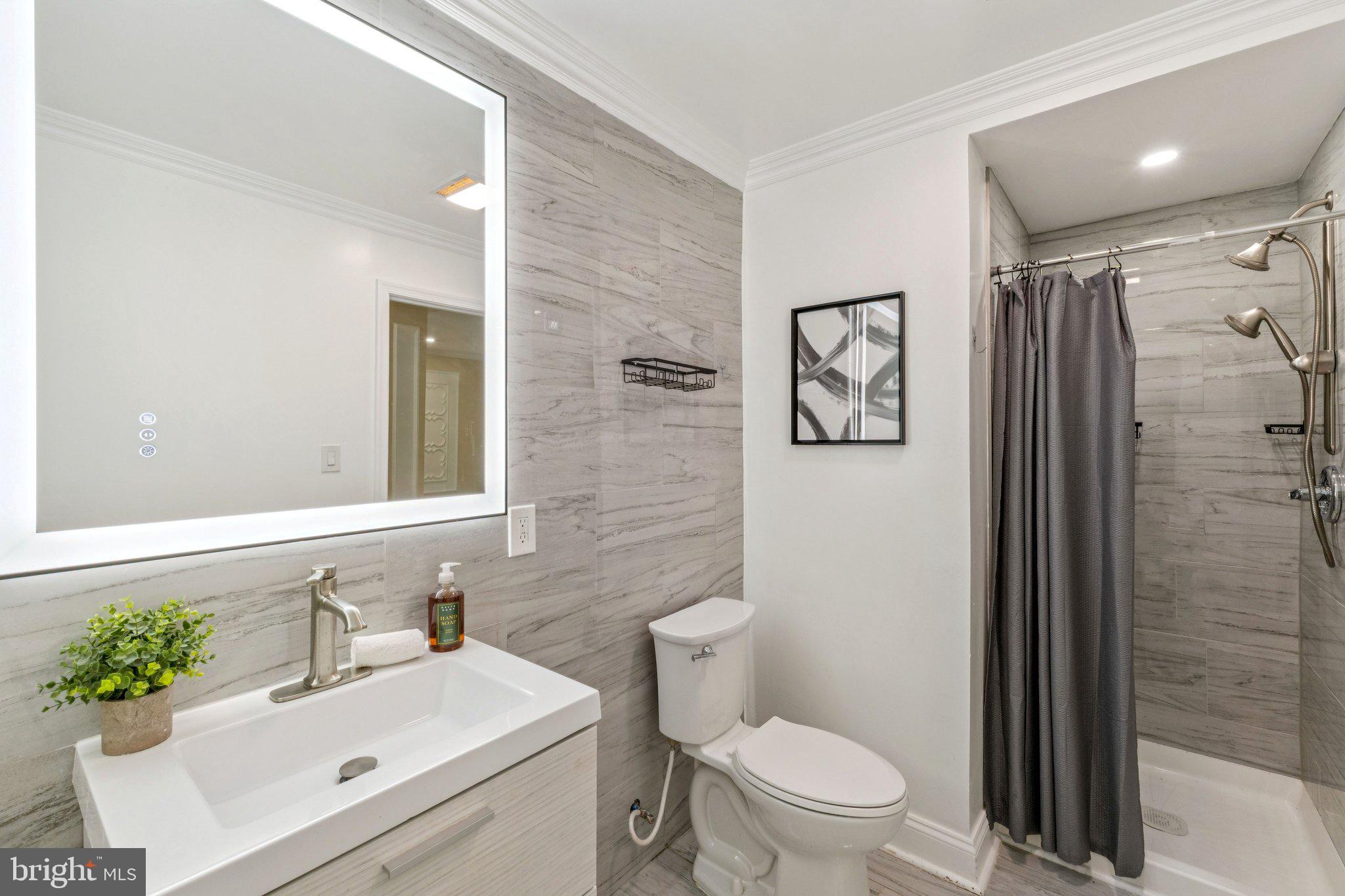 2205 Dhow Court Bowie, MD 20721 - Photo 34 of 40 a bathroom with a sink toilet and shower