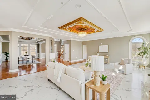 a living room with dining table and a large window