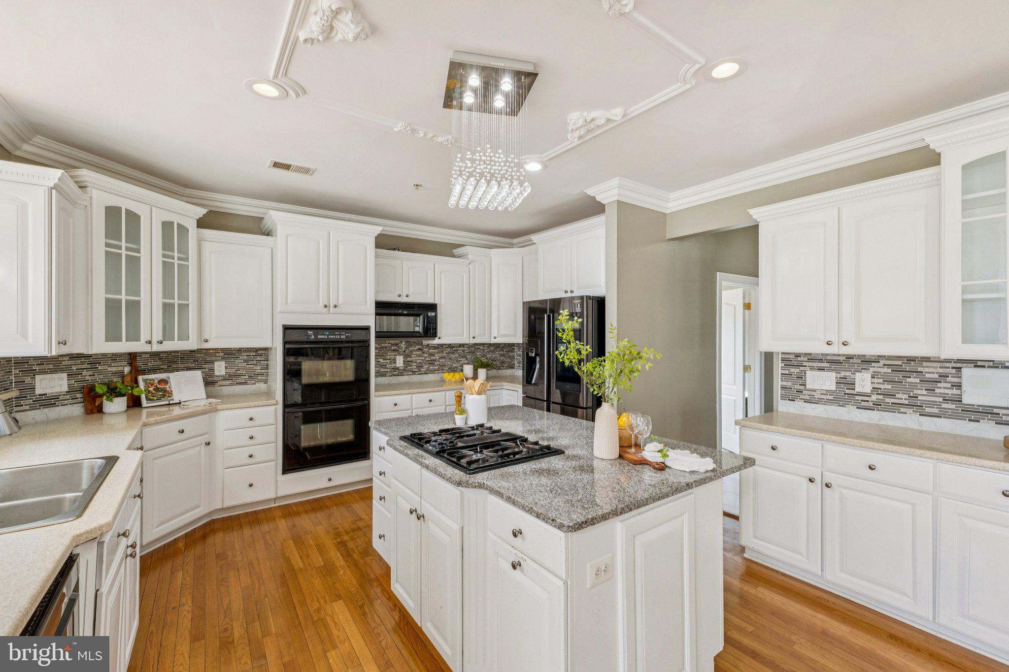 2205 Dhow Court Bowie, MD 20721 - Photo 9 of 40 a kitchen with granite countertop a sink appliances cabinets and counter space
