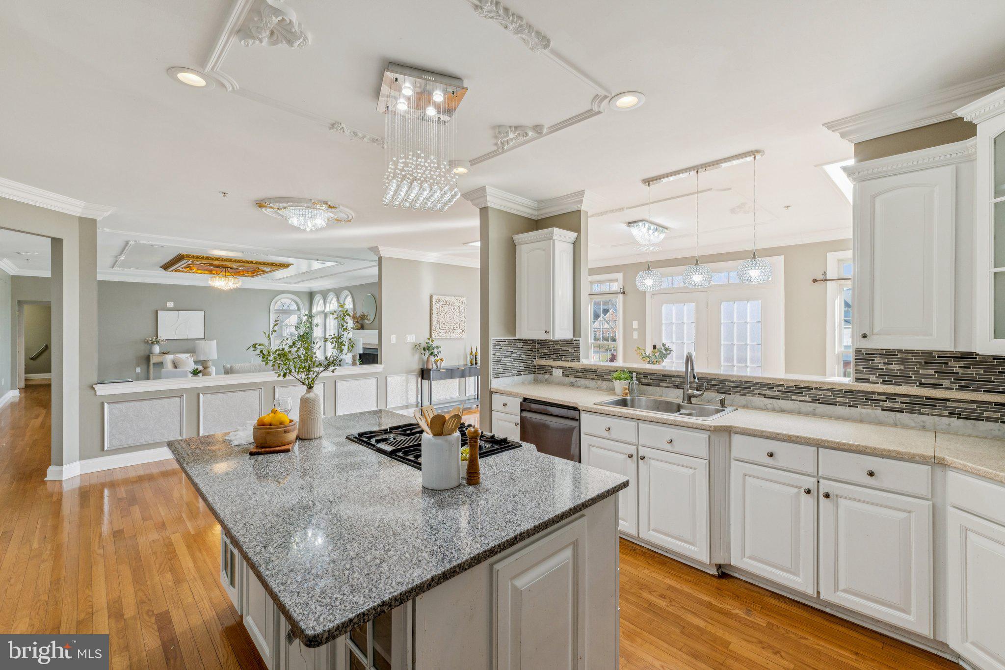2205 Dhow Court Bowie, MD 20721 - Photo 10 of 40 a kitchen with a stove a sink dishwasher a kitchen island with wooden cabinets and floor