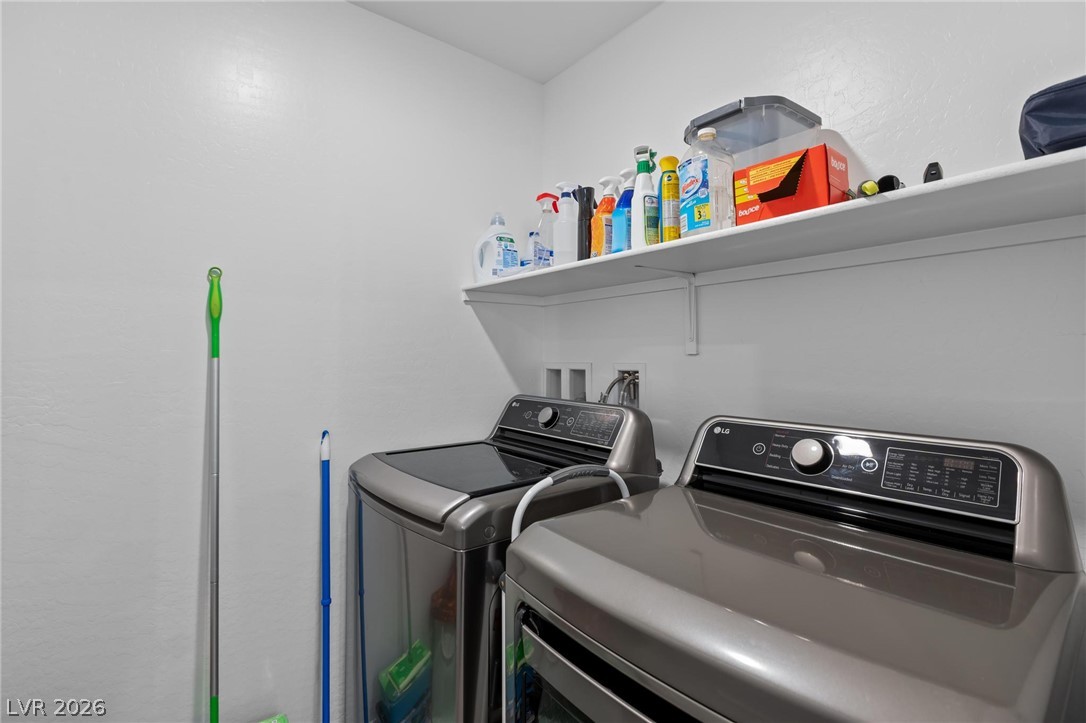 7310 North Decatur Boulevard, Unit 4 North Las Vegas, NV 89084 - Photo 24 of 35 A dedicated utility space with contemporary washer and dryer units for seamless home management.
