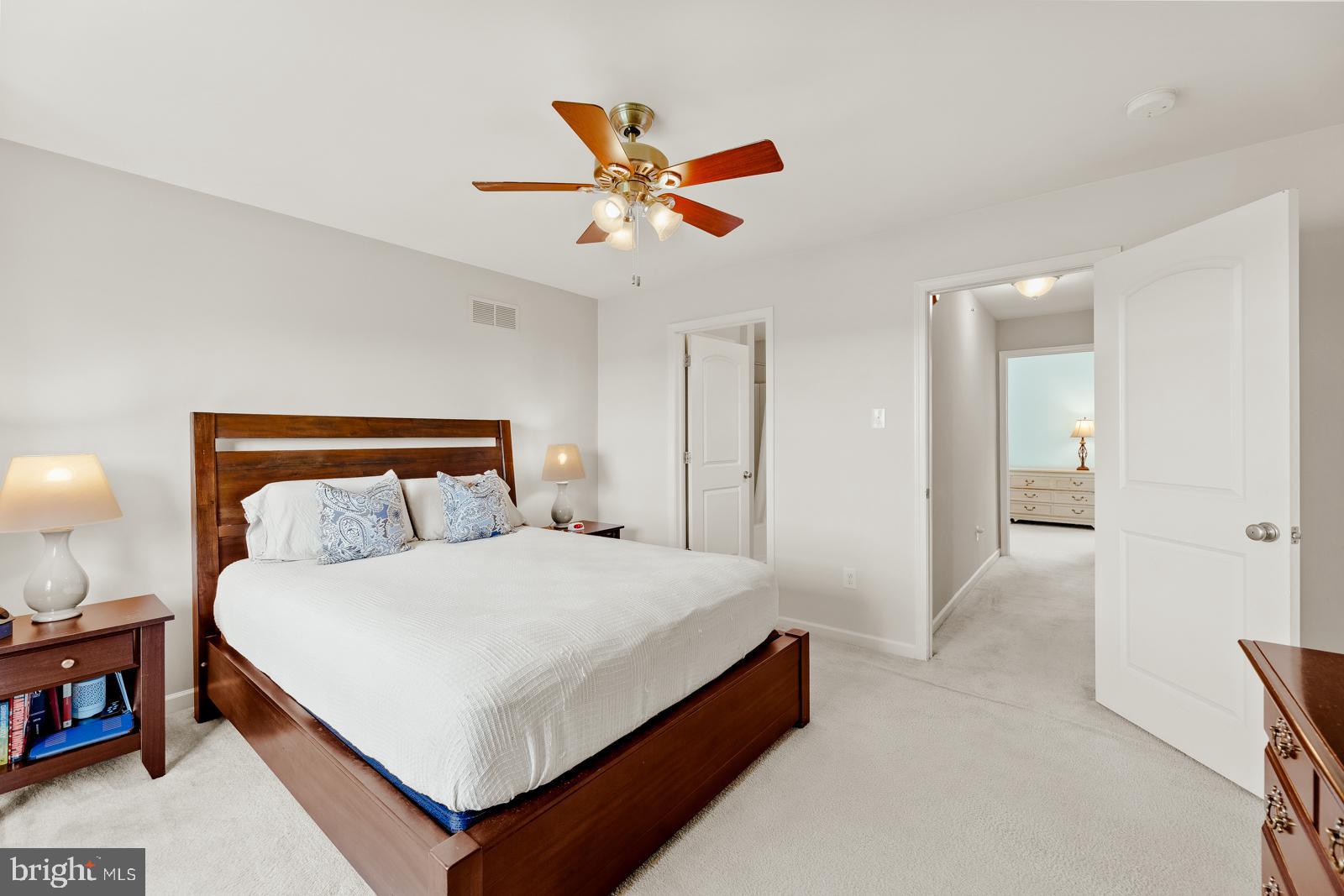 3669 Jacob Stout Road, Unit 8 Doylestown, PA 18902 - Photo 15 of 38 a bedroom with a bed and a chandelier