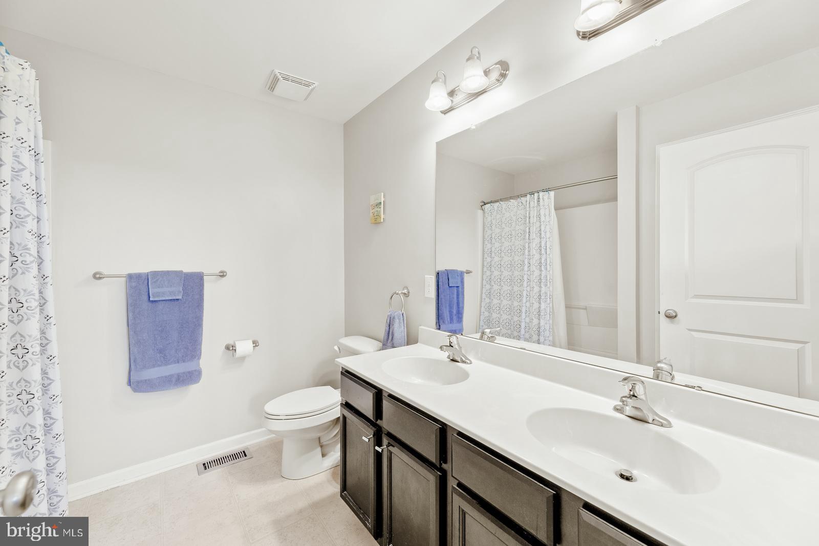 3669 Jacob Stout Road, Unit 8 Doylestown, PA 18902 - Photo 18 of 38 a bathroom with a sink a toilet a large mirror and shower