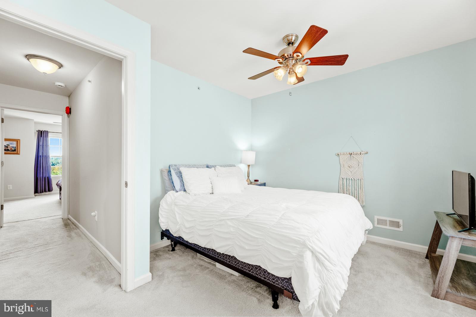 3669 Jacob Stout Road, Unit 8 Doylestown, PA 18902 - Photo 22 of 38 a bedroom with a bed and a chandelier