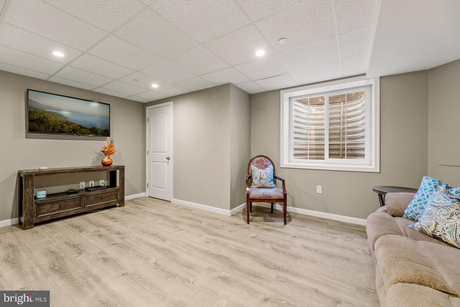 3669 Jacob Stout Road, Unit 8 Doylestown, PA 18902 - Photo 28 of 38 a living room with furniture a flat screen tv and a window