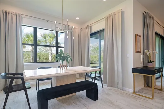 a view of a dining room with furniture window and outside view