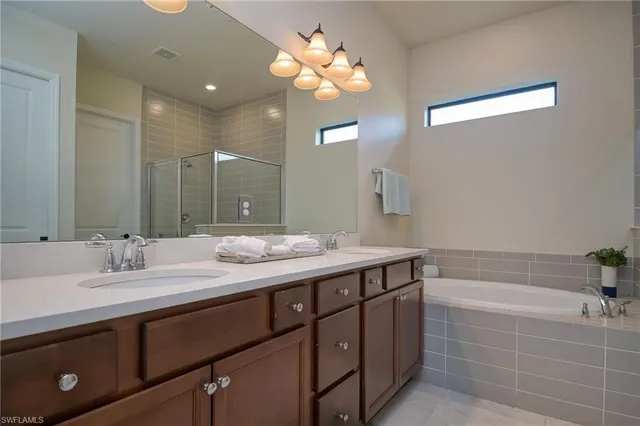 a bathroom with a double vanity sink and a mirror