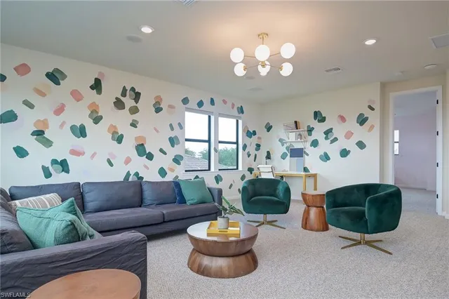a living room with furniture and a chandelier
