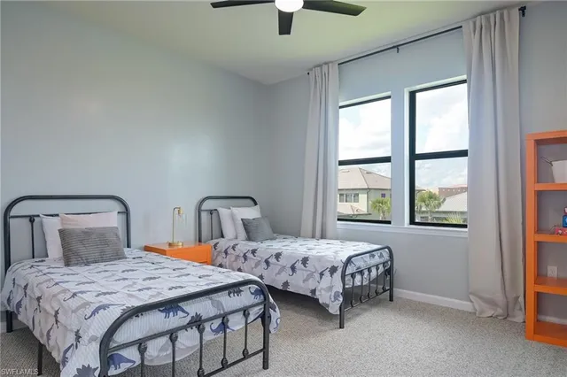 a bedroom with two beds and a window