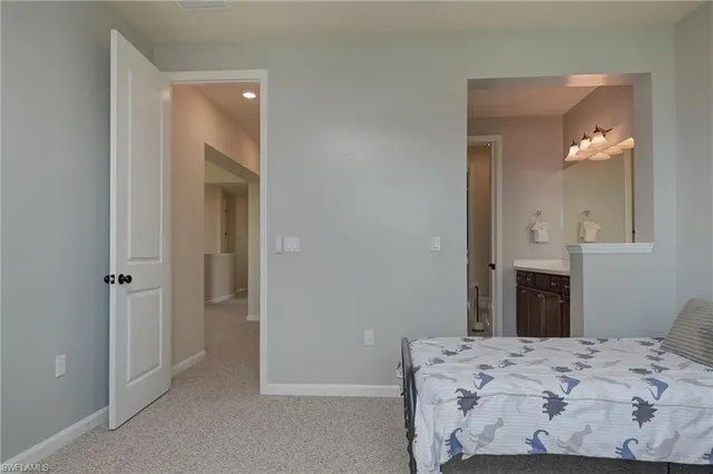 a bedroom with a bed and a mirror