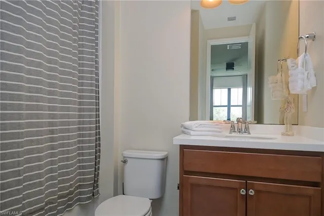 a bathroom with a sink toilet and mirror